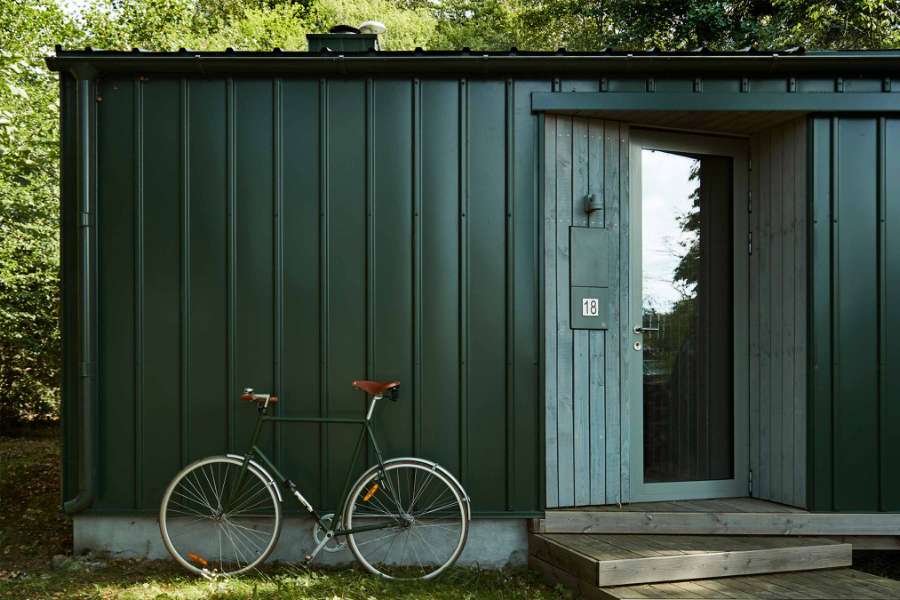 Newly constructed summer cottage with green steel panels 